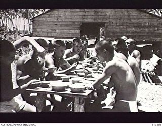 NAURU ISLAND. 1945-09-15. JAPANESE TROOPS EATING THEIR LUNCH IN ONE OF THE POW CAMPS CONTROLLED BY TROOPS OF THE 31/51ST INFANTRY BATTALION
