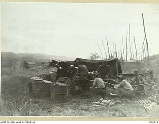 DAGUA, NEW GUINEA. 1945-03-25. NO.4 GUN, F TROOP, 52ND BATTERY, 2/2 FIELD REGIMENT, ROYAL AUSTRALIAN ARTILLERY FIRING A ROUND OF RANGING FIRE FROM A FORWARD POSITION AT THE AIRSTRIP