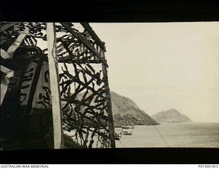 Port Moresby, New Guinea. 1942-1943. A view from the 67th Anti-Aircraft Searchlight Battery's command post on Paga Point. A camouflaged Sperry searchlight is in the foreground. The command post ..