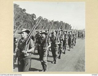 LAE, NEW GUINEA. 1944-10-07. A MARCHL PAST OF THE 2/8TH COMMANDO SQUADRON. IDENTIFIED PERSONNEL ARE:- SIGNALLER A.J. THURSTON (1); SIGNALLER J.R. BESNARD (2); SIGNALLER F.W. WILSON (3); SIGNALLER ..