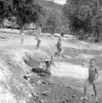 Children swimming in bay