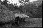 Fainjur: house and unwalled structure near thickly forested steep slope