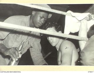 LAE, NEW GUINEA. 1944-07-22. PRIVATE N. DORSEY, SECOND (UNITED STATES OF AMERICA) ATTENDING TO PRIVATE PAT MCVEY (UNITED STATES OF AMERICA) (2) DURING A BOXING TOURNAMENT BETWEEN AUSTRALIAN AND ..