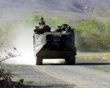 An USMC AAV7A1 Amphibious Assault Vehicle moves along a dirt road at Bellows, Air Force Station, Oahu, Hawaii while conducting training with USMC personnel assigned to L/Company, 3rd Battalion, 3rd Marine Regiment