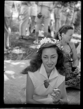 Welcoming reception, young women sitting on mat, Tahiti