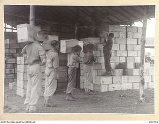 CAPE WOM, WEWAK AREA, NEW GUINEA, 1945-07-02. MEMBERS OF 2/22 SUPPLY DEPOT PLATOON RECEIVING AND STACKING SUPPLIES WHICH HAVE RECENTLY ARRIVED BY SHIP