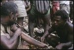 Man measures a lousu'u, the most basic unit of shell money