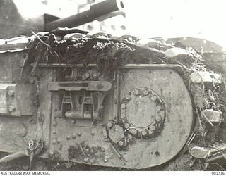 MADANG, NEW GUINEA. 1944-10-12. PLOUGH GUARDS REMOVED SHOWING MUD PACKED UNDER TRACKS DURING TANK TESTS AT HQ 4 ARMOURED BRIGADE
