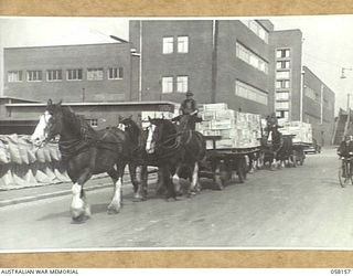 KENSINGTON, VIC. 1943-10-23. A LOAD OF FLOUR ON A HORSE DRAWN CART LEAVING THE MILLS OF MESSRS. KIMPTON AND SONS FOR DESPATCH BY SHIP TO THE TROOPS IN NEW GUINEA
