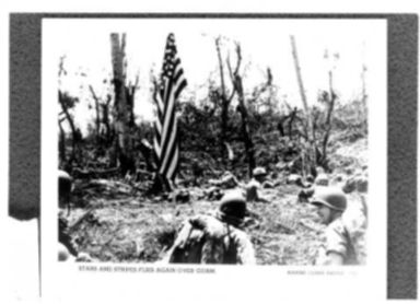 WORLD WAR II: STARS & STRIPES FLIES AGAIN OVER GUAM - PHOTO OF UNIDENTIFIED SOLDIERS STANDING IN A FIELD