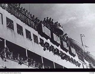 SYDNEY, NSW. 1946-05-09. TROOPS LINING THE DECKS OF TROOPSHIP DUNTROON, CHEER AS SHE BERTHS AT CIRCULAR QUAY AFTER HER TRIP FROM KURE, MOROTAI AND RABAUL