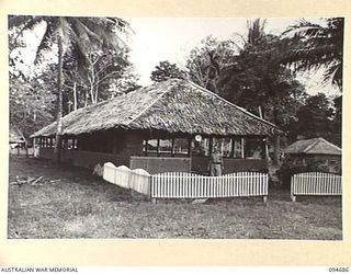 YALU, NEW GUINEA. 1945-08-03. CHAPLAIN R.E. WILLIAMSON OUTSIDE THE YALU CHAPEL AT THE NEW GUINEA TRAINING SCHOOL