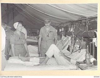 TOROKINA, BOUGAINVILLE. 1945-07-03. HIS ROYAL HIGHNESS, THE DUKE OF GLOUCESTER, GOVERNOR-GENERAL OF AUSTRALIA (2), WITH SISTER M.E. KIEL (1), SPEAKING TO WARRANT OFFICER II TROY (3), DURING HIS ..