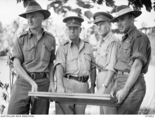 SIAR, NEW GUINEA. 1944-08-19. THE BRIGADIER AND HIS NATIVE OFFICERS OF HEADQUARTERS, 7TH INFANTRY BRIGADE. IDENTIFIED PERSONNEL ARE:- QX40880 CAPTAIN A.A. KREBS, STAFF CAPTAIN (1); TX2002 BRIGADIER ..