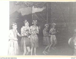 LAE, NEW GUINEA. 1944-08-17. "THE HULA GIRLS" OF THE WHITE HORSE INN CONCERT PARTY GO INTO THEIR SONG AND DANCE ROUTINE DURING "THE WHITE HORSE INN" STAGED AT HEADQUARTERS, NEW GUINEA FORCE. THE ..