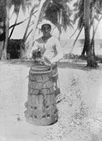 Man playing a village drum for dancing, Manihiki, Cook Islands