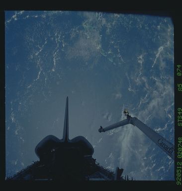 S49-85-074 - STS-049 - Dark views of RMS arm over payload bay