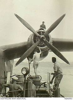 Port Moresby, Dutch New Guinea. 1944-09-21. A Papuan native (right) assists to refuel a Martin PBM Mariner flying boat aircraft of No. 41 (Transport Sea) Squadron RAAF based at Cairns, from a ..