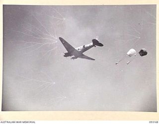 MOROKAIMORO, BOUGAINVILLE, 1945-06-12. A DOUGLAS C47 DAKOTA TRANSPORT DROPPING FRESH SUPPLIES TO 2/8 COMMANDO SQUADRON GROUND FORCES