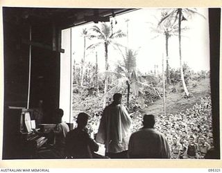 PALMALMAL PLANTATION, JACQUINOT BAY, NEW BRITAIN, 1945-08-19. THE CHAPLAIN ADDRESSING HEADQUARTERS 5 SUB-AREA TROOPS DURING THE THANKSGIVING SERVICE HELD AT THE CAMEO THEATRE AT THE END OF ..