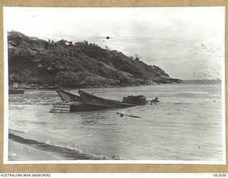 NEW GUINEA. 1943-12-29. ONE OF THE MANY WRECKED JAPANESE BARGES WHICH LITTER THE COASTLINE