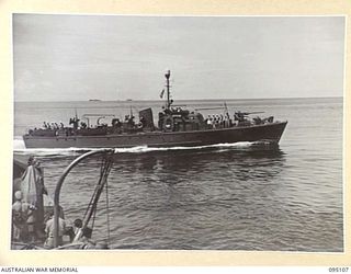 AT SEA, OFF BUIN, BOUGAINVILLE, 1945-08-20. A ROYAL AUSTRALIAN NAVY FAIRMILE CRUISING BY THE CORVETTE HMAS LITHGOW DURING NEGOTIATIONS WITH THE SURRENDER ENVOY FROM LIEUTENANT-GENERAL M. KANDA, ..