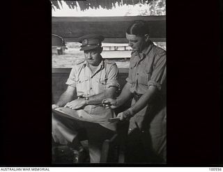 Lae, New Guinea. 1944-06-29. Brigadier A. G. Torr, Chief Electrical and Mechanical Engineer, HQ New Guinea Force (left), discussing the camp layout plans with Captain J. L. S. Mansfield