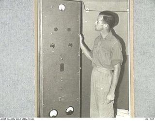 LAE, NEW GUINEA. 1945-09. THE TRANSMITTER PANEL AT LAE RADIO STATION. 9.AB. THIS TRANSMITTER WAS ORIGINALLY BUILT FROM JUNK, MAINLY JAPANESE, BUT IS NOW MOSTLY OF AUSTRALIAN AND AMERICAN ORIGIN