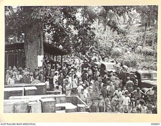 RATONGOR, NEW BRITAIN. 1945-09-18. JUBILATION AT A CHINESE CIVILIAN INTERNEE CAMP WHEN, FOLLOWING THE JAPANESE SURRENDER, 22 TONS OF ARMY RATIONS AND RED CROSS SUPPLIES ARRIVED AT THE CAMP. ..