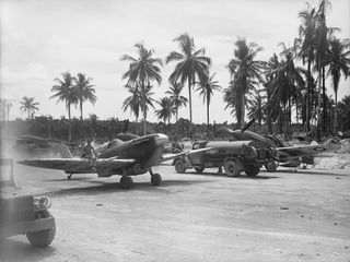 MOMOTE, LOS NEGROS ISLAND, ADMIRALTY ISLANDS. C. 1944-04. AIRCRAFT OF NO. 79 (SPITFIRE) SQUADRON RAAF, TAXIING ALONG A DISPERSAL ROAD AT MOMOTE AIRFIELD