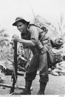 MARINGGUSIN, NEW GUINEA, 1943-09-29. NX127188 SIGNALLER P.L.W. LAMB OF THE 2/16TH AUSTRALIAN INFANTRY BATTALION APPEARS TIRED AFTER A LONG TREK CARRYING A PORTABLE WIRELESS WEIGHING 28 POUNDS, AS ..