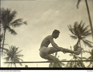 MADANG, NEW GUINEA. C. 1944-10. 122206 LEADING AIRCRAFTMAN E. S. GIBBS, TUNLEY BAY, SA, WINS THE HIGH JUMP AT A RAAF SPORTS MEETING AT THE FORWARD BASE WITH A CLEAR JUMP OF 5 FT 3 INS