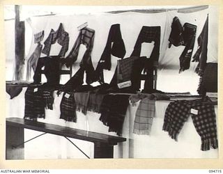 LAE AREA, NEW GUINEA, 1945-08-04. SCARVES ON DISPLAY IN THE WEAVING SECTION AT THE ARTS AND CRAFTS EXHIBITION HELD AT THE RED CROSS SOCIETY HUT, 2/7 GENERAL HOSPITAL. BOTH HOSPITAL STAFF AND ..