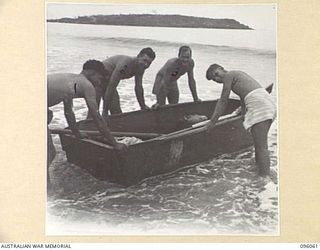 WIRUI BEACH, WEWAK AREA, NEW GUINEA. 1945-09-05. TROOPS OF 2/11 INFANTRY BATTALION WITH A ROWING BOAT. IDENTIFIED PERSONNEL ARE:- LANCE CORPORAL T. TABER (1); PRIVATE C.V. SMITH (2); PRIVATE R. ..