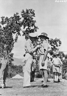 BUNA, NEW GUINEA. C. 1943. WHILE PINNING THE UNITED STATES SILVER STAR TO THE BREAST OF FLYING OFFICER ELTON MURRAY IFOULD OF PYMBLE, NSW, BRIGADIER-GENERAL ENNIS C. WHITEHEAD UNITED STATES ARMY ..