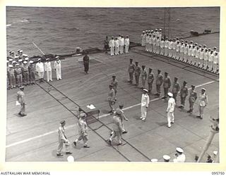 AT SEA OFF RABAUL, NEW BRITAIN. 1945-09-06. LIEUTENANT GENERAL V.A.H. STURDEE, GENERAL OFFICER COMMANDING FIRST ARMY, AND PARTY, TAKING UP POSITIONS FOR THE SURRENDER CEREMONY ON THE AIRCRAFT ..