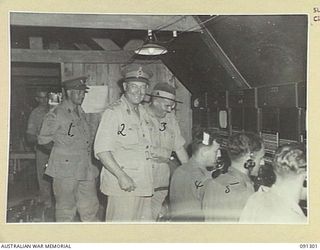 TOROKINA, BOUGAINVILLE. 1945-04-27. MAJOR-GENERAL C.H. SIMPSON, SIGNAL OFFICER- IN- CHIEF (2), WITH COLONEL R.C. REEVE, CHIEF SIGNAL OFFICER 2 CORPS (3), AND COLONEL R.W. SAVAGE, CHIEF SIGNAL ..