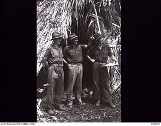 FARIA VALLEY, NEW GUINEA. 1943-10-22. OFFICERS OF THE 2/27TH AUSTRALIAN INFANTRY BATTALION OUTSIDE THE UNIT COMMAND POST AT GUY'S POST. LEFT TO RIGHT: SX2921 CAPTAIN J. H. BEARE, ADJUTANT; VX35 ..