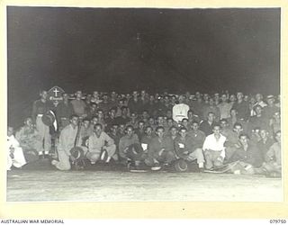 TOROKINA, BOUGAINVILLE, SOLOMON ISLANDS. 1945-03-14. THE 72 CONFIRMEES WITH VX91744 CHAPLAIN P.N.W. STRONG, ANGLICAN BISHOP OF NEW GUINEA OUTSIDE THE TENT CHAPEL OF THE 2/1ST GENERAL HOSPITAL. THE ..