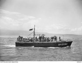 JACQUINOT BAY, NEW BRITAIN. 1945-08-31. THE HOSPITAL LAUNCH (AH2090) OF 53 PORT CRAFT COMPANY ROYAL AUSTRALIAN ENGINEERS, ARRIVING FROM TOL WITH PATIENTS FOR 2/8 GENERAL HOSPITAL