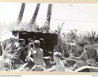 NAGADA, NEW GUINEA. 1944-08-16. THE GUN CREW OF E TROOP, 22ND BATTERY, 106TH TANK ATTACK REGIMENT DOING A PRACTICE SHOOT ON THE BEACH NEAR THEIR CAMP. IDENTIFIED PERSONNEL ARE:- VX71206 GUNNER R.B. ..