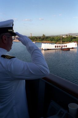 An officer aboard the guided missile cruiser USS CHOSIN (CG-65) salutes as his ship approaches the USS ARIZONA MEMORIAL during an observance commemorating the 50th anniversary of the Japanese attack on Pearl Harbor
