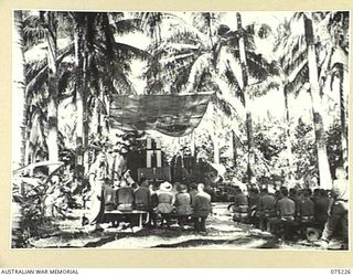 NORTH ALEXISHAFEN, NEW GUINEA. 1944-08-10. THE OPEN AIR CHURCH OF ENGLAND CHAPEL WHICH WAS DECORATED BY THE TWO AUSTRALIAN ARMY NURSING SERVICE SISTERS IN THE FOREGROUND, NFX77275 SISTER K.E. ..