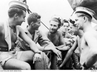 Arawe, New Britain. December 1943. Australian sailors who helped to transport United States troops in their assault on Arawe. Left to right: Able Seaman Mick Sparkes of Croydon, SA; Martin Fischer ..