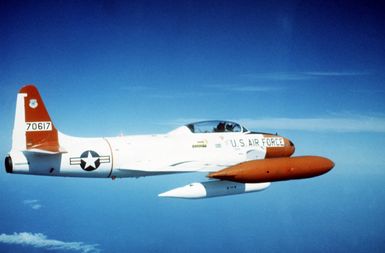 An air-to-air right side view of A T-33 Shooting Star aircraft over Hawaii participating in Exercise Cope Canine '85
