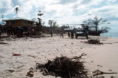 Villagers help unload supplies from a 53rd Aviation Battalion UH-60 Black Hawk helicopter following its arrival on the island of Savaii. Military personnel from the United States and other nations are providing such services to Savaii and the island of Upolu as part of disaster relief efforts in the aftermath of Cyclone Ofa