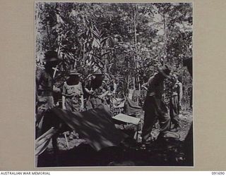 WIDE BAY, NEW BRITAIN, 1945-05-05. MAJ-GEN C.H. ROBERTSON, GOC 5 DIVISION (4), INSPECTS THE PERIMETER DEFENCES OF 16 INFANTRY BATTALION, SITUATED IN FORWARD POSITIONS NORTH OF TOL PLANTATION. ..