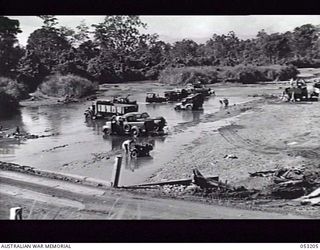 MILNE BAY, NEW GUINEA. 1943-06-26. DRIVERS OF HEADQUARTERS, 5TH AUSTRALIAN DIVISION WASHING THEIR VEHICLES AT HAGITI BRIDGE ON THE KALOHI CREEK