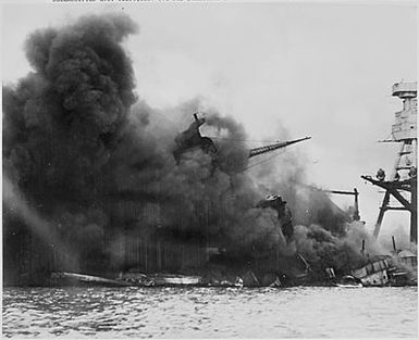 Naval photograph documenting the Japanese attack on Pearl Harbor, Hawaii which initiated US participation in World War II. Navy's caption: The USS ARIZONA afire and sinking after the Japanese attack on Pearl Harbor on Dec. 7, 1941.
