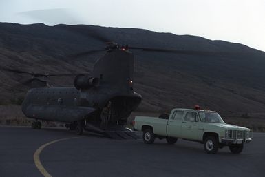 A member of the 25th Military Police Company drives a truck off a CH-47 Chinook helicopter for use at the Pohakuloa Training Area during Exercise OPPORTUNE JOURNEY 4-84